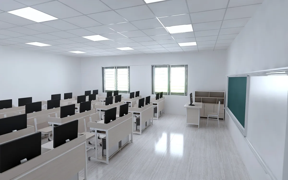 Phòng máy tính nhìn dọc theo dãy bàn, có vách ngăn giữa các máy